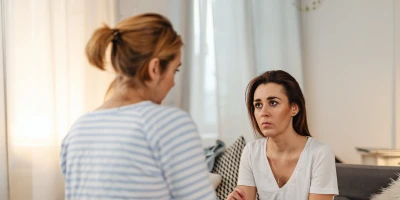 two women talking intently